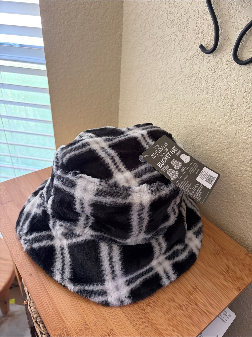 Sprigs reversible Faux Fur bucket hat in black and black and white pattern
